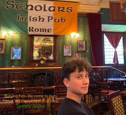 Portrait of Anton seated inside Scholars Irish Pub in Rome beneath a large Irish flag, paired with a James Joyce quotation referencing Caesar and the “ides of March,” evoking the political intrigue of Shakespeare’s Julius Caesar.